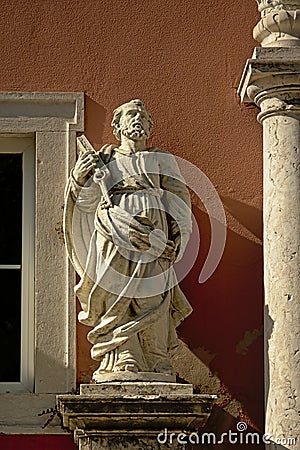 Statue of saint Peter holding the keys of heavenand a holy book with the gospel Editorial Stock Photo