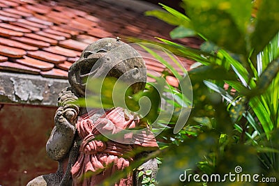 The statue is sent to smile the way through the past. Stock Photo