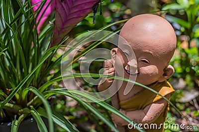 The statue is sent to smile the way through the past. Stock Photo