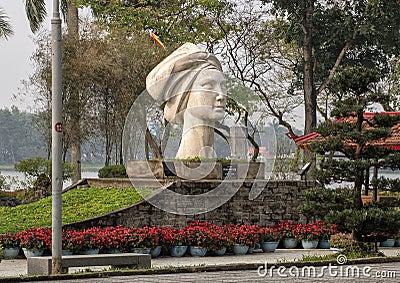 The statue of a Vietnamese girl, sculpted by Le Thanh Nhon, located in Hue along the Parfume River. Editorial Stock Photo