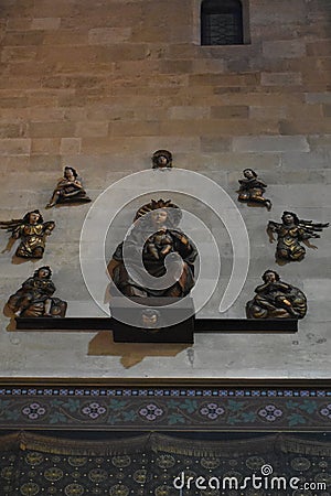 Statue of Virgin Mary with a child Jesus Christ on the wall of the cathedral behind the altar. Editorial Stock Photo