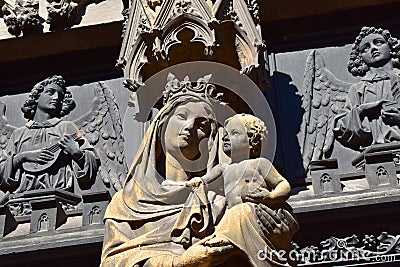 The statue of the Virgin Mary at the entrance door of the church in France.. Stock Photo