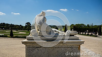 A statue of a woman in the gardens of Versailles Stock Photo