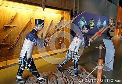 Statue of Zhuang farmers playing sheng in Anthropology Museum Of Guangxi, adobe rgb Editorial Stock Photo