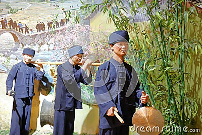 Statue of Zhuang farmers beating the gong and drum in Anthropology Museum Of Guangxi, adobe rgb Editorial Stock Photo