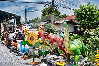 Statues of dinos and other animals in a shop in Thailand Editorial Stock Photo