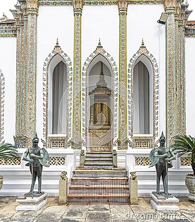 Statues of the guardian warriors at the gate of Phra Wiharn Yod Buddhist Temple in Bangkok, Thailand Stock Photo