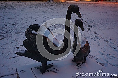 Statue of a pair of swans under the snow in December. Berlin, Germany Stock Photo