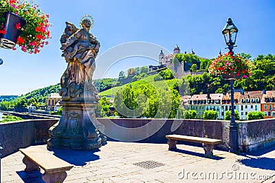 Statues of St Mary stands on a dragon on the Old Main Bridge. Summer cityscape. Wurzburg is a city located on Main River. Germany Stock Photo