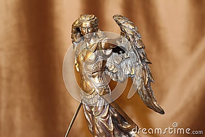 Statuette of the Archangel Michael on a velour background Stock Photo