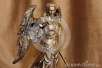 Statuette of the Archangel Michael on a velour background Stock Photo