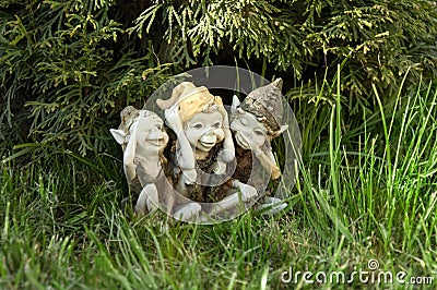 Statuette of elves not hearing not seeing not talking in the grass Stock Photo