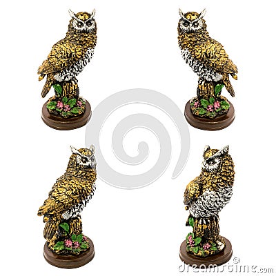 Statuettes of gold owls with flowers isolated on a white background Stock Photo