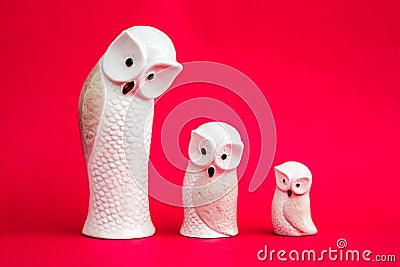 Statuettes of White Owls on Pink Background Stock Photo