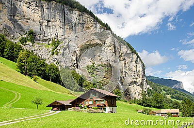Staubbach valley with chalet in front - Lauterbrunen, Switzerland Stock Photo