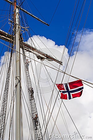 STAVANGER, NORWAY - CIRCA SEPTEMBER 2016: Three crew members climb up a Norwegian ship`s mast Editorial Stock Photo