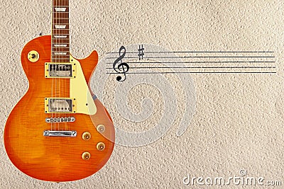 Stave and honey sunburst vintage electric guitar on the left side of rough cardboard background. Stock Photo