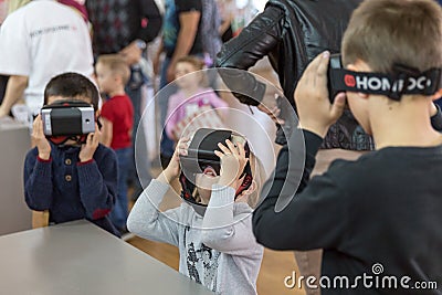 STAVROPOL, RUSSIA - APRIL 6, 2019 - Children having fun with virtual reality headsets in robot museum Editorial Stock Photo