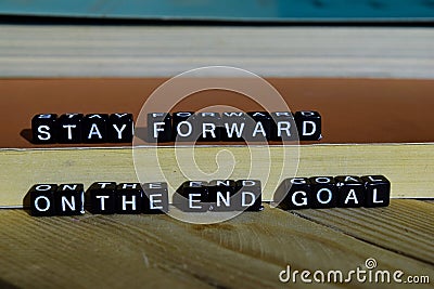 Stay forward on the end goal on wooden blocks. Motivation and inspiration concept Stock Photo