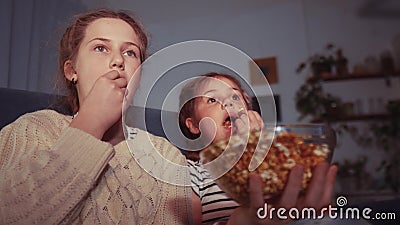 stay home quarantine. family - children eat popcorn watching tv. kid dream together coronavirus concept. popcorn. happy Stock Photo