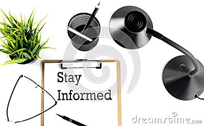 STAY INFORMED text on a clipboard on the white background Stock Photo