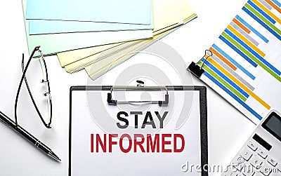 STAY INFORMED text on paper sheet with chart,color paper and calculator Stock Photo