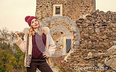 Stay warm and fashionable. Woman wear furry coat. Winter clothes. Wardrobe for cold weather. Girl stand near stone ruins Stock Photo