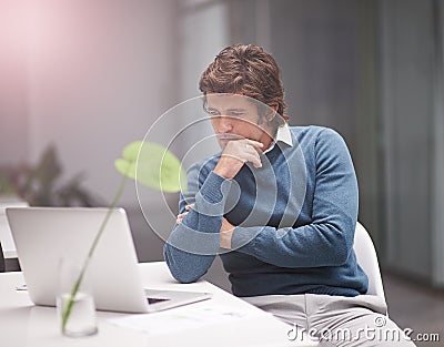 Staying ahead of the business curve with technology. a businessman working on a laptop in an office. Stock Photo