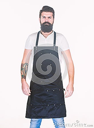 Staying clean and comfortable with chef apron. Bearded man cook in kitchen apron. Cook with long beard wearing bib apron Stock Photo