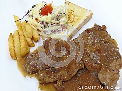 Steak, French fries and vegetables Stock Photo