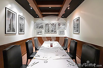 Steak house restaurant interior design with contemporary luxury furniture in New York style, elegant black leather chairs. Editorial Stock Photo