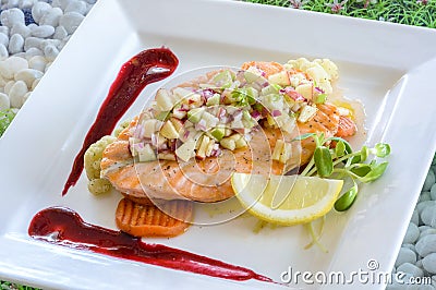 Steak salmon with apple salsa and berry sauce Stock Photo