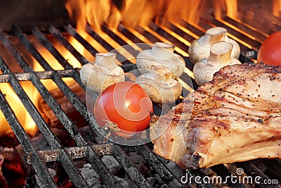 Steak and Vegetables Char-Grilled Over Flaming BBQ Grill Stock Photo