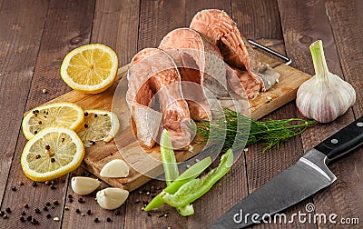 Steaks raw trout are on the board with spices Stock Photo