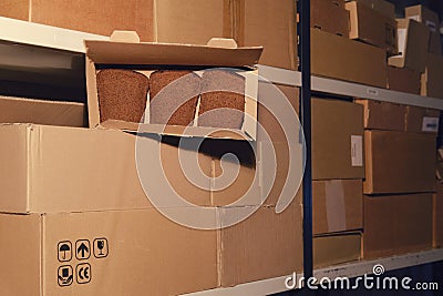 Stealing bread in a warehouse during a lockdown. Empty warehouse with opened boxes of food Stock Photo