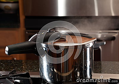Steam escaping from new pressure cooker pot Stock Photo