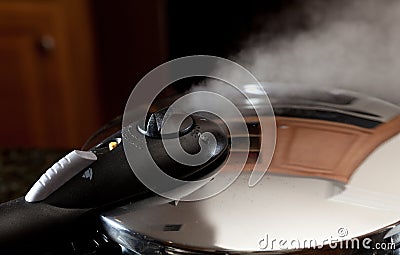 Steam escaping from new pressure cooker pot Stock Photo