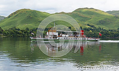 Steam ferry with holidaymakers and tourists Ullswater Lake District with green hills Editorial Stock Photo