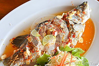 Steamed fish with lime - Thai food Stock Photo