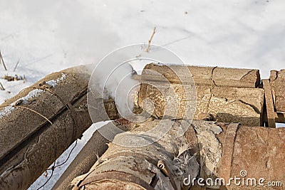 Steam leak through a crack in exhaust pipe heating Stock Photo