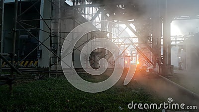 Steam leak in industial behind sunset background Stock Photo