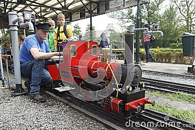 Steam miniature train repairer Editorial Stock Photo