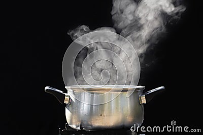 Steam over cooking pot Stock Photo