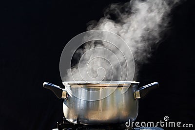 Steam on pot in kitchen Stock Photo