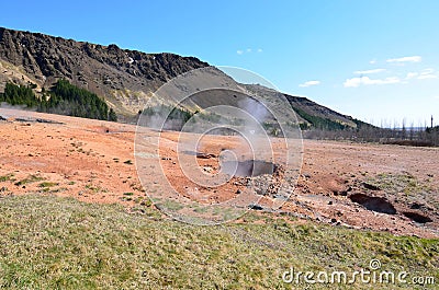 Steam Rising from Craters and Pock Marked Landscape Stock Photo