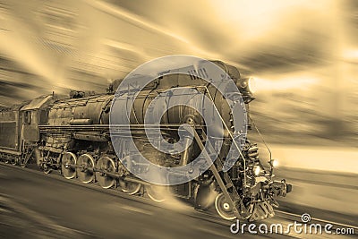 Steam train goes fast on the night station background. Stock Photo