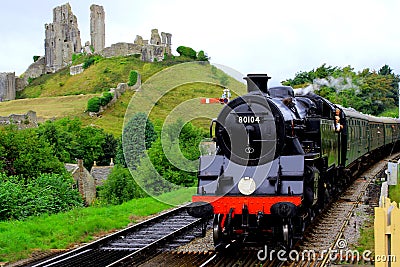 Steam Train passing Corfe Castle Editorial Stock Photo