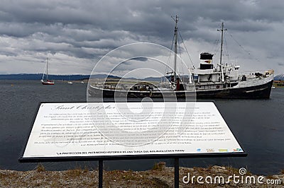 Steam tug Saint Christopher Grounded in the Beagle Channel.Information for tourists. Editorial Stock Photo