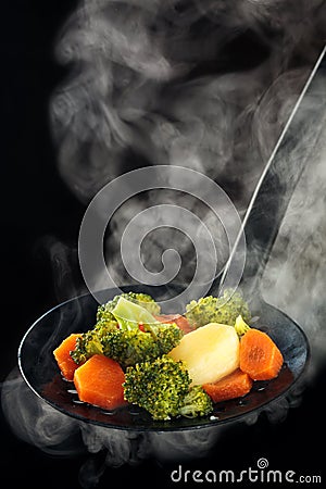 Steamed vegetables and steam. Stock Photo