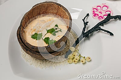 Steamed brown sticky rice in coconut shell, Thai traditional food. Stock Photo